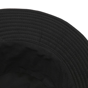 Detailed close-up of a black cotton bucket hat featuring reinforced stitching on the brim
