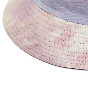 Detailed macro view of tie-dye bucket hat featuring lavender fabric and reinforced stitching