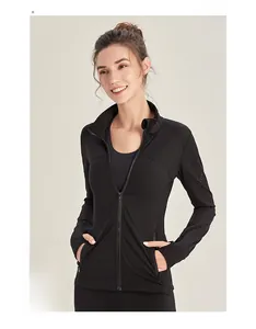 Detail view of black women's zip-up sports jacket featuring thumbholes and stand collar