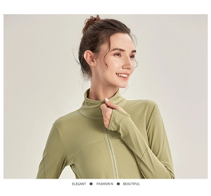 Detail view of avocado green sports top featuring thumb holes and laser-cut breathability