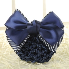Close-up of navy blue satin bow hairnet with blue and white striped ribbon detail