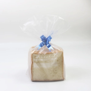 Detail of clear toast packaging with a blue ribbon bow and festive ribbon closure