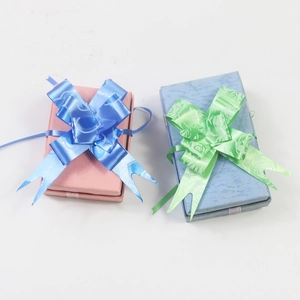 Detail of pink and light blue gift boxes with large decorative ribbon bows on top