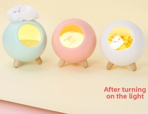 Detailed view of creative cat night light with wooden legs and soft warm yellow lighting