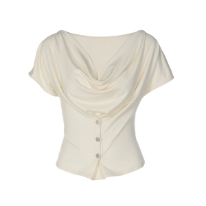 Detail view of cowl neck draping and decorative buttons on ivory short sleeve top