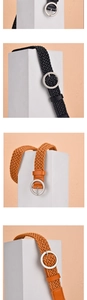 Detailed view of woven wax rope belts in black and brown with round metal buckles