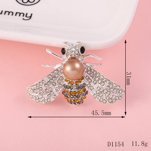 Detail view of a 45mm bee brooch with pearls and rhinestones on a white display tray