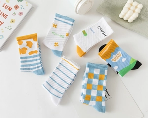 Flat lay view of six pairs of cotton mid-calf socks with striped and checkered patterns