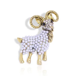 Exquisite golden sheep brooch featuring white pearls and sparkling rhinestone accents