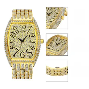 Macro detail of luxury tonneau quartz watch featuring 18K gold plating and full iced-out diamonds