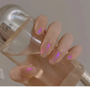 Gros plan d'ongles aurore rose avec une finition nacrée irisée violette et bleue