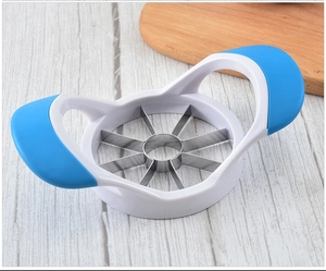 Top-view of a stainless steel apple slicer and corer with blue non-slip handles on wood