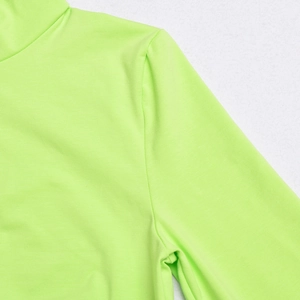 Close-up of neon green bodysuit neck and shoulder stitching with smooth ribbed fabric