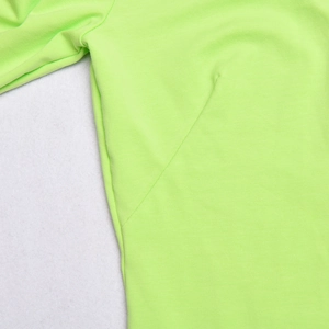 Detail view of the fluorescent green bodysuit showing the flatlock stitching and knit fabric
