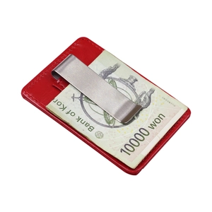 Red leather slim wallet card holder with a metal money clip holding a banknote