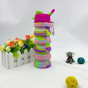 Detail view of foldable silicone sports bottle with tie-dye pattern and metal carabiner