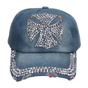 Close-up of rhinestone cross pattern and distressed denim detail on baseball cap