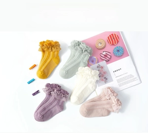 Close-up of ruffled lace trims and hollow-out knit patterns on five-color girl socks