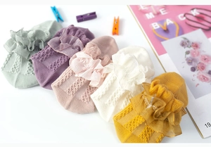 Flat lay of five pairs of cotton lace princess socks for girls in assorted pastel colors