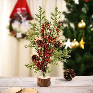 Mini Christmas tree ornament with red berries, pine cones, and a natural wooden base