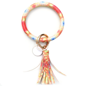 Detail of colorful tassel keychain with golden spring clasp and patterned wristlet ring