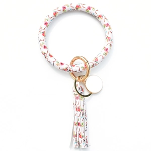 Detail of floral cow skull printed PU leather bangle keychain with fringe and metal ring