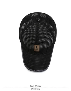 Detail view of black breathable mesh baseball cap with brown leather brand patch on top