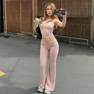 Pink two-piece set featuring a halter crop top and high-waisted flared trousers for women