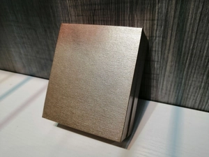 Detail view of champagne gold square jewelry gift box with brushed metal texture finish