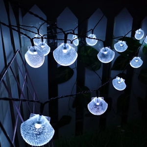 Solar powered shell shaped LED string lights with cool white glow for garden decor