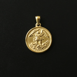 Macro view of a 18K gold plated titanium steel angel relief coin pendant