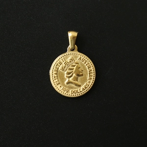 Macro detail of 18K gold-plated titanium steel coin pendant with Queen Elizabeth portrait