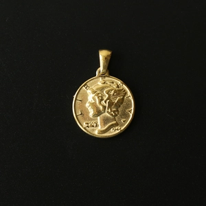 Macro detail of 18K gold plated titanium steel coin pendant with Mercury Liberty relief