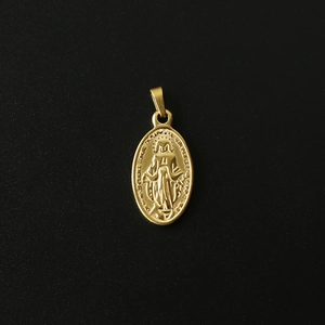 Macro view of golden oval Virgin Mary pendant with detailed 18K gold plated embossing