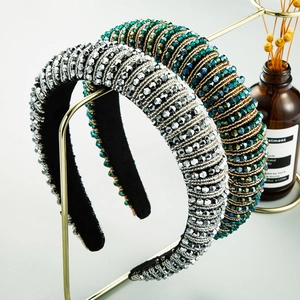 Close-up of wide beaded headband with silver and peacock green crystals and velvet lining