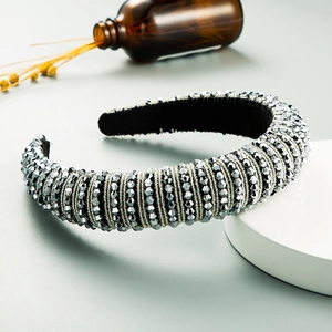 Detailed view of luxury baroque headband featuring gray metallic beads on black fabric