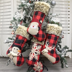 Rustic Christmas stockings set with red plaid fabric, faux fur trim, and festive embroidery