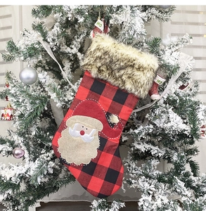 Hanging burlap Christmas stocking with Santa Claus embroidery and red-black plaid pattern