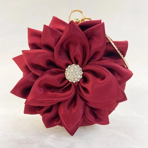 Detailed view of dark red satin floral evening bag with crystal rhinestones center