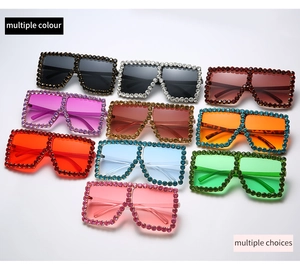 Macro shot of oversized square sunglasses featuring hand-set rhinestones in multiple colors