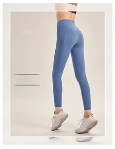 Detail view of mist blue high-waisted yoga leggings showing peach lift seam and stretch fabric