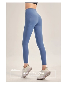 Detail view of high-waisted morandi blue yoga pants with peach butt lift design