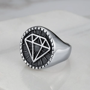 Macro side view of vintage punk signet ring with diamond emblem and textured edges