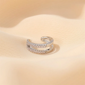 Double layered silver ear cuff with pink micro zircons on soft beige silk fabric