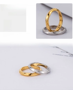 Macro view of polished Mobius ring bands with mirror-finish 18K gold and silver plating