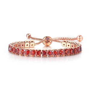 Macro shot of rose gold adjustable bracelet featuring square-cut red zircon stones