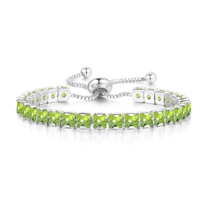 Detailed close-up of adjustable tennis bracelet with square green zircons and sliding clasp