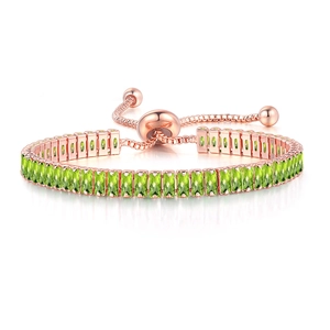 Macro shot of rose gold adjustable bracelet with rectangle green zircon stones