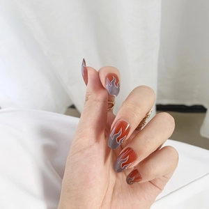 Red flame press-on nails with dark grey contrast and sleek long almond shape nails