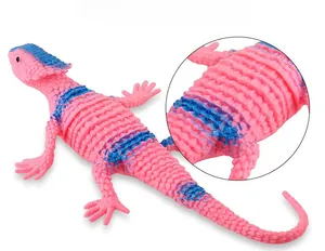 Detailed macro view of pink chameleon toy with blue spots and realistic scale texture